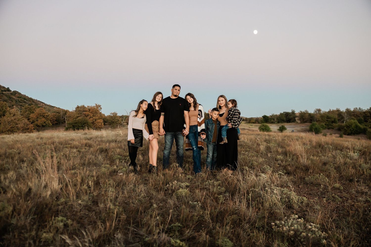 Group portrait on a hilltop with soft evening light.