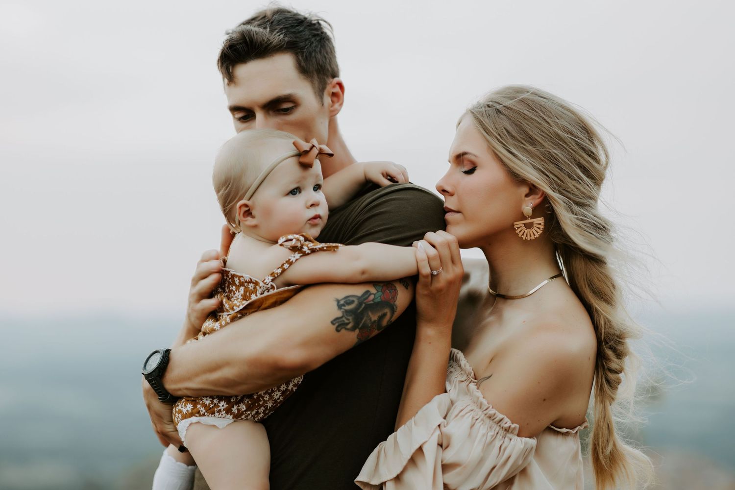 Romantic couple poses together in a series of intimate outdoor portraits at sunset.