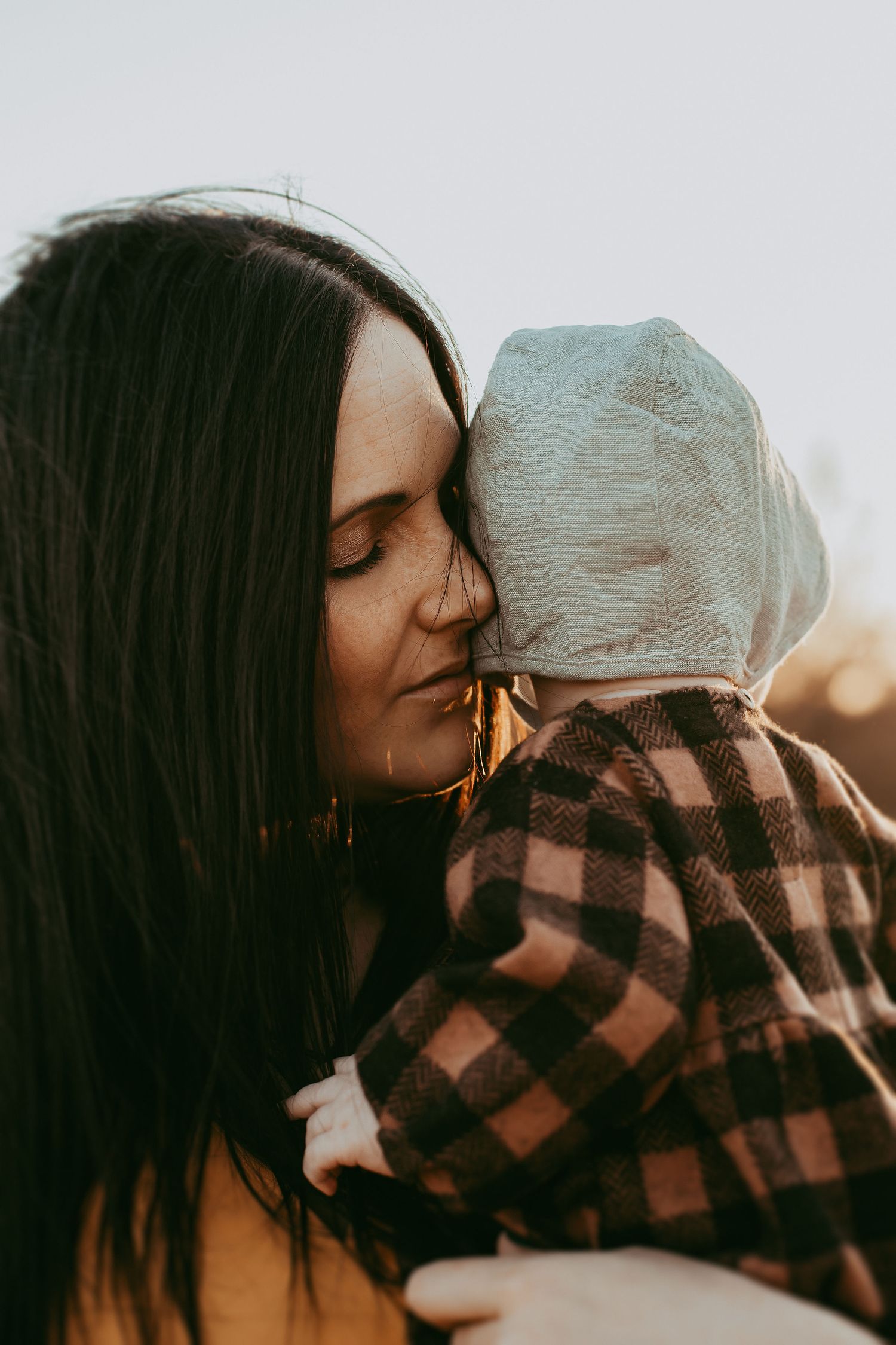 A romantic sunset moment captured in silhouette with warm golden light.