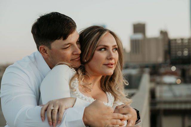 Intimate couple portrait session during golden hour with urban backdrop.