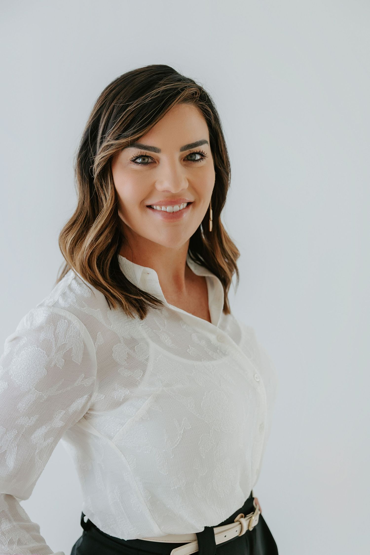 Professional headshots in white blouse against neutral background.