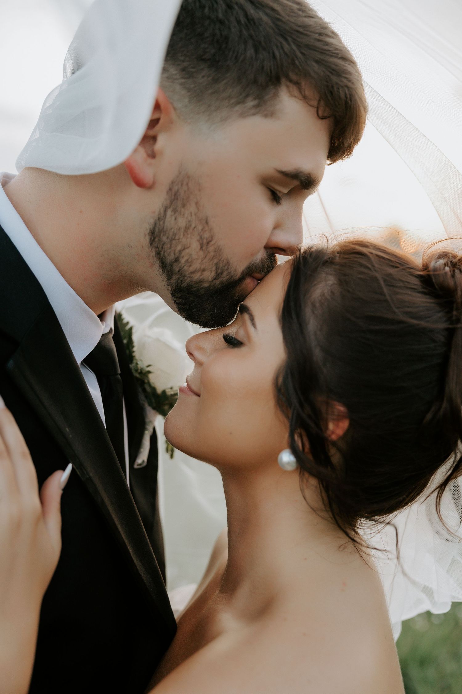 Intimate black and white wedding portraits showing tender moments between newlyweds.