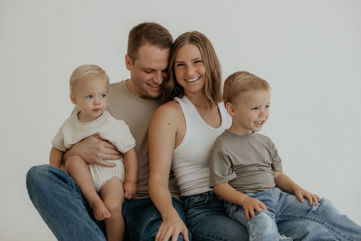 Cozy indoor lifestyle family photoshoot in neutral tones with natural lighting.