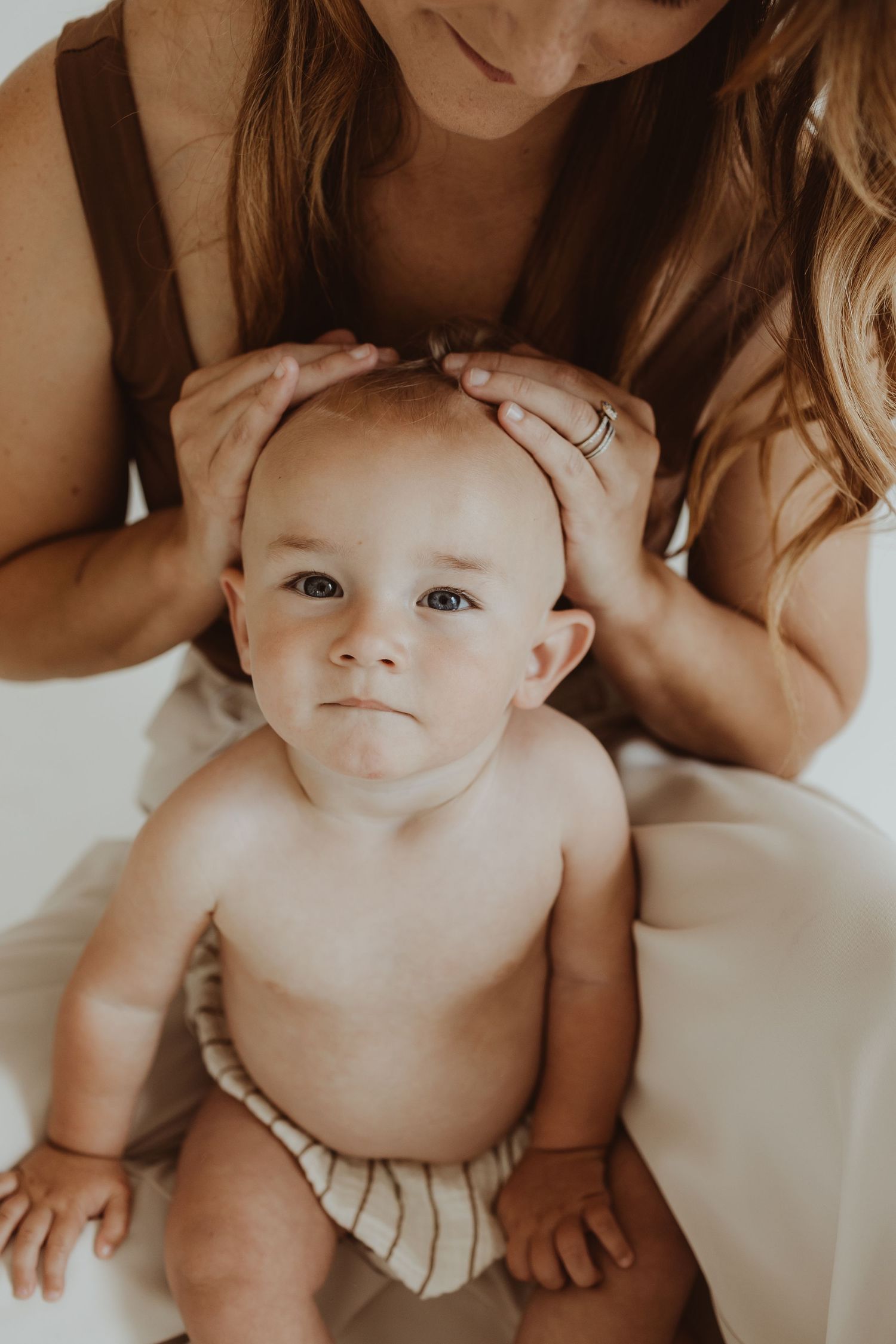Close-up portrait on white background showing tender family interaction.