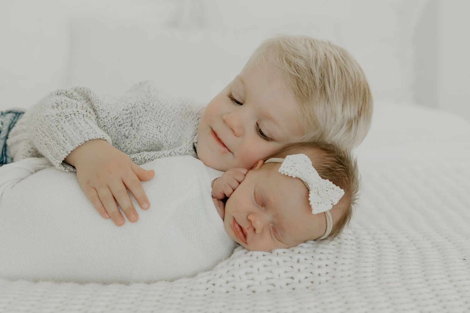 Peaceful sleeping baby in soft white bedding.