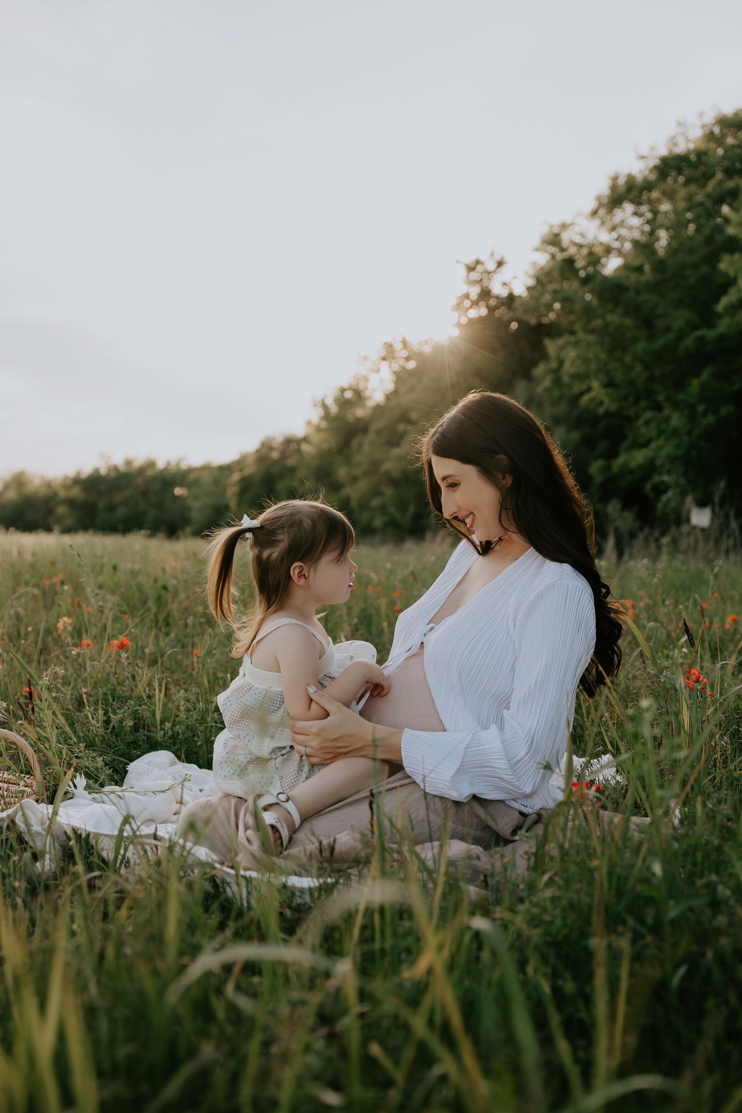Two people sharing an intimate moment while relaxing in a field of wildflowers.
