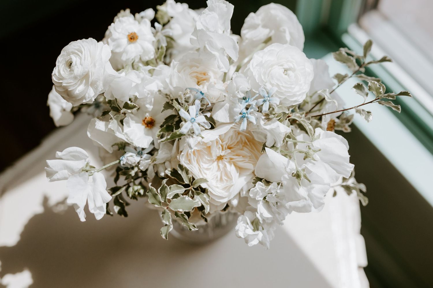 White floral arrangement with delicate petals and greenery.