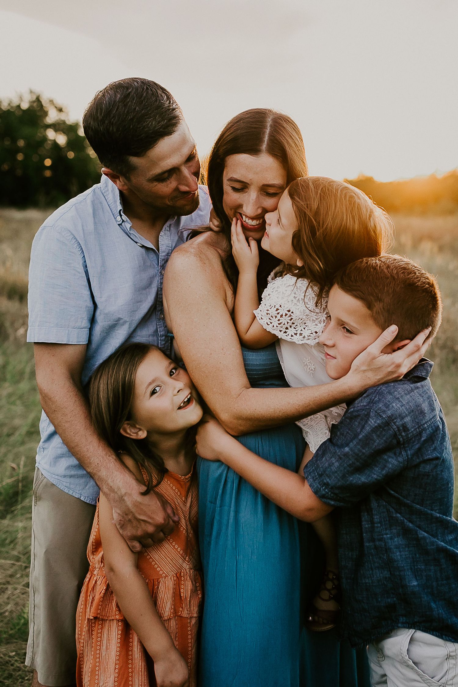 Family sharing intimate embrace during golden hour photo session.