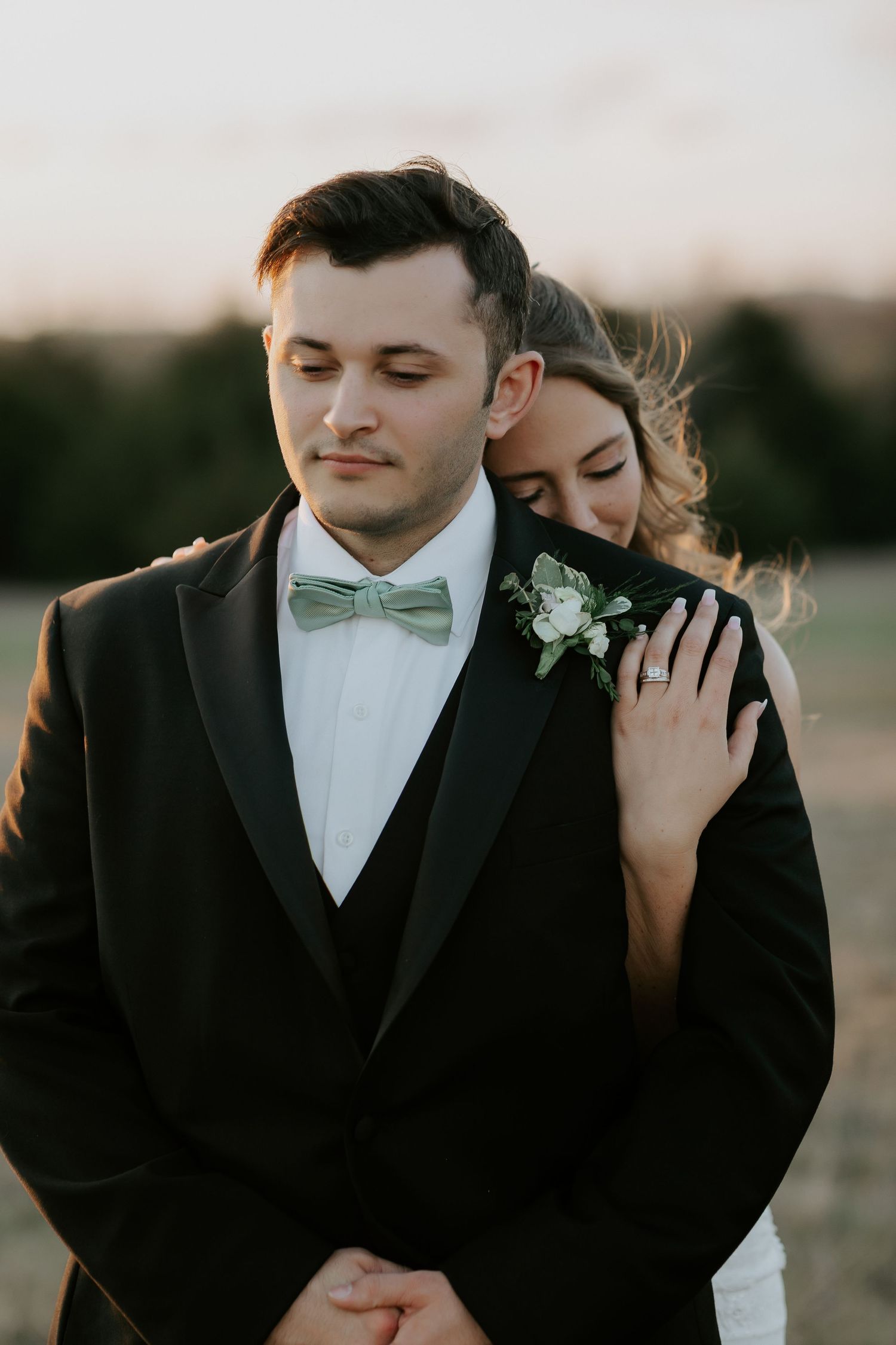 Romantic sunset wedding portraits with couple in formal attire and mint bow tie.