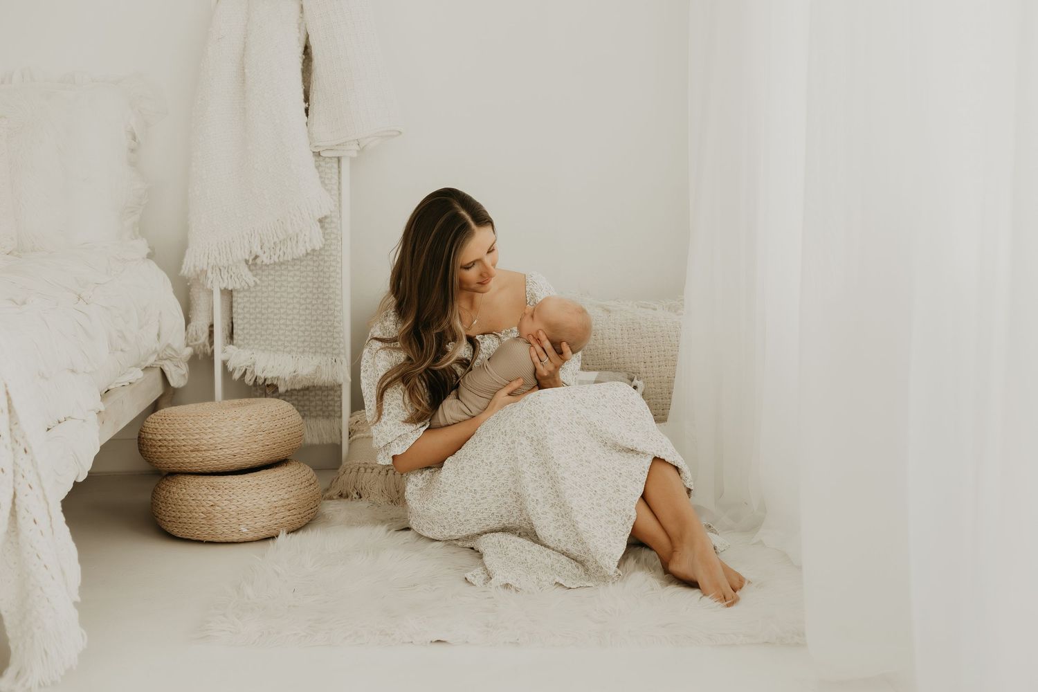 Peaceful nursery scene with caregiver and baby in white decor.