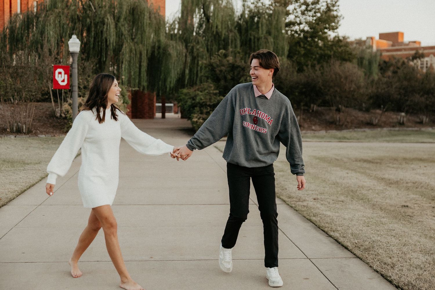 Couple walking and playing together on a scenic pathway.
