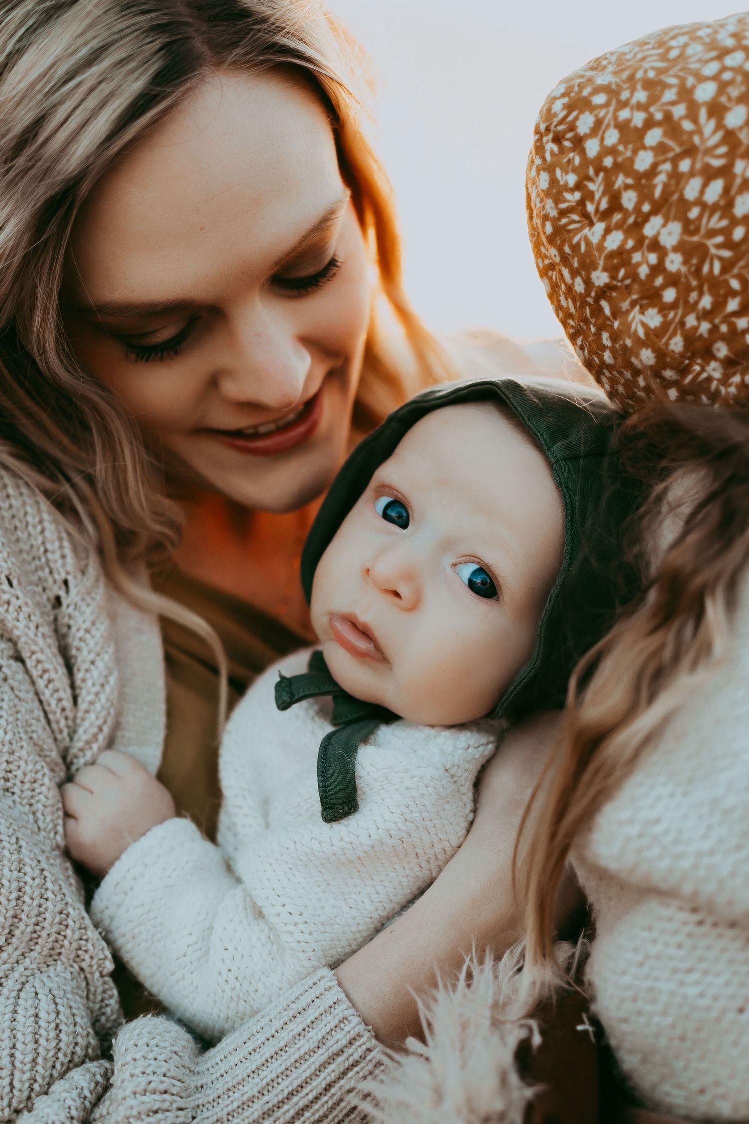 Close-up intimate moment between parent and child wearing cozy knit sweaters.