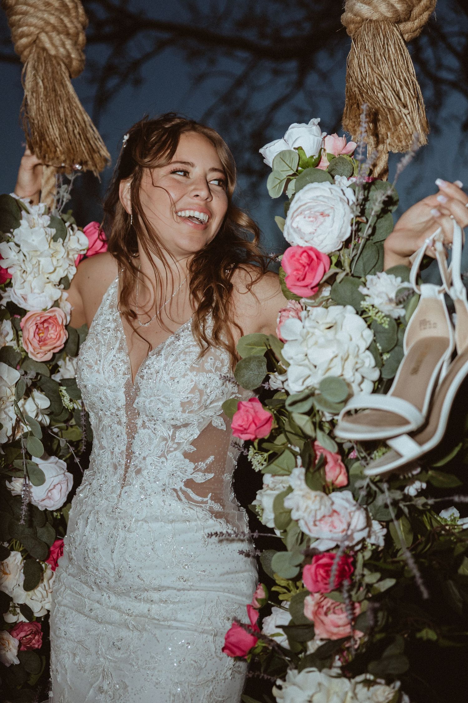 Artistic detail shots of a lace wedding dress with pink and white floral arrangements.