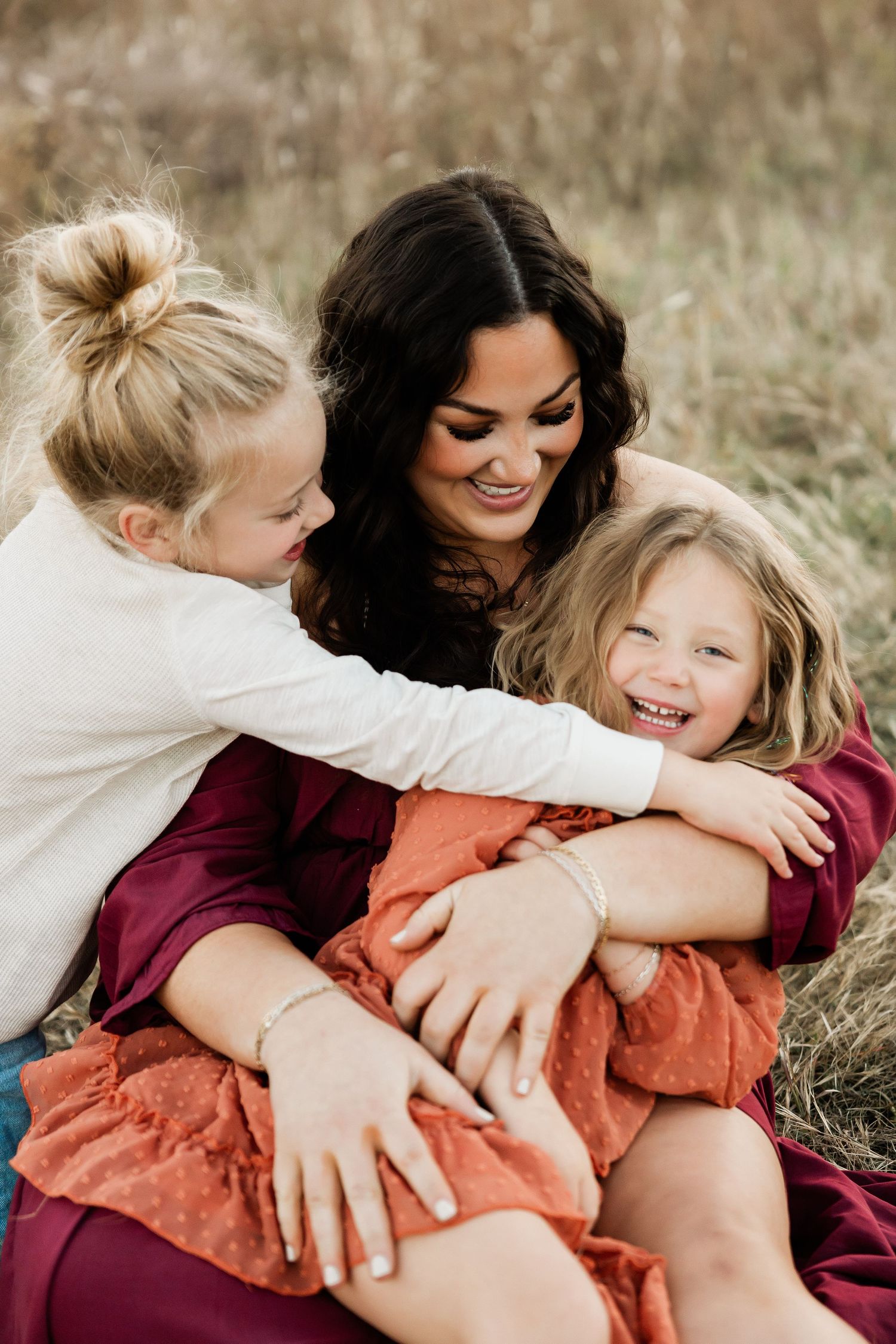 A series of candid shots showing playful hugging moments in an autumn field setting.