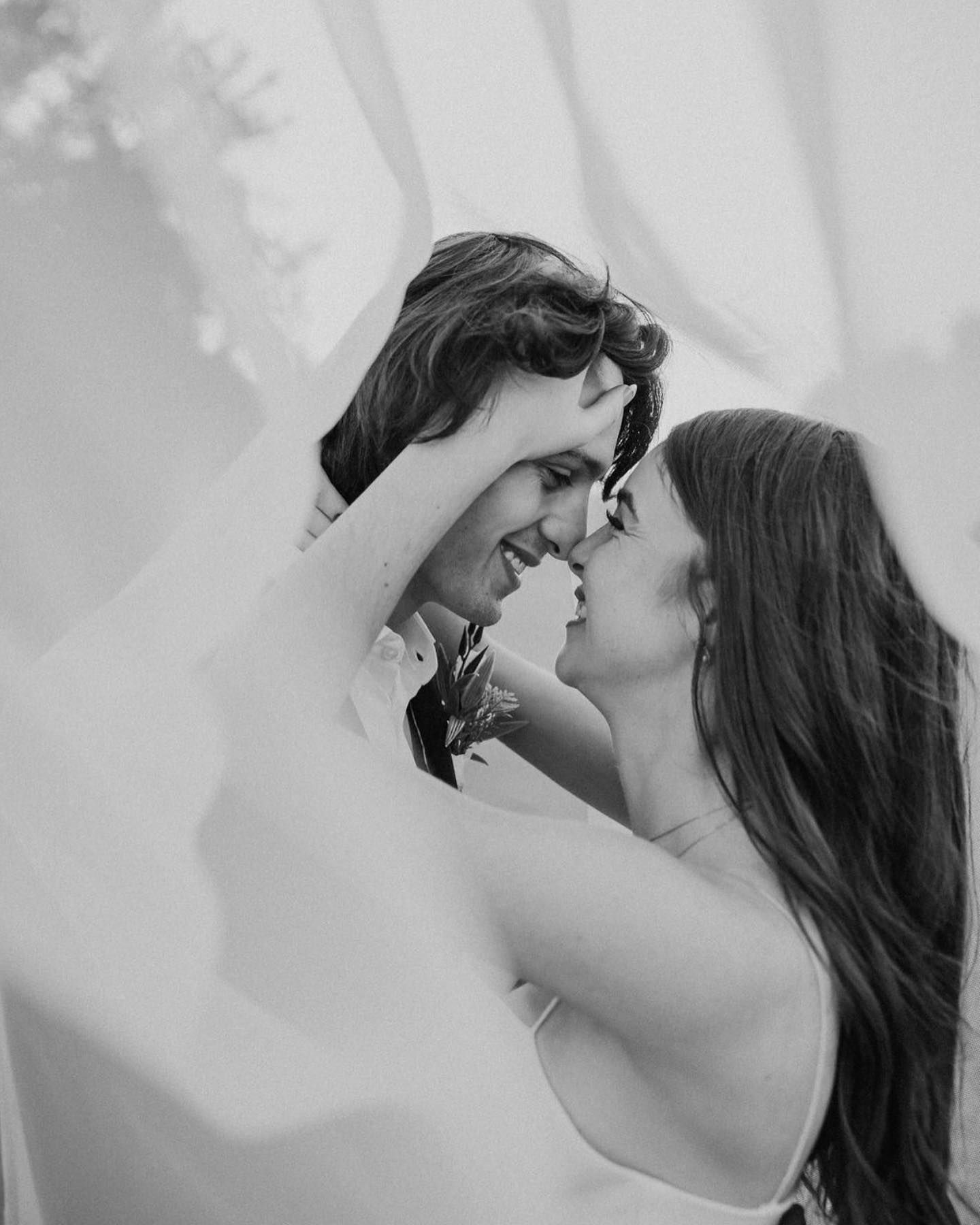 Black and white intimate romantic portrait with soft lighting and shadows.