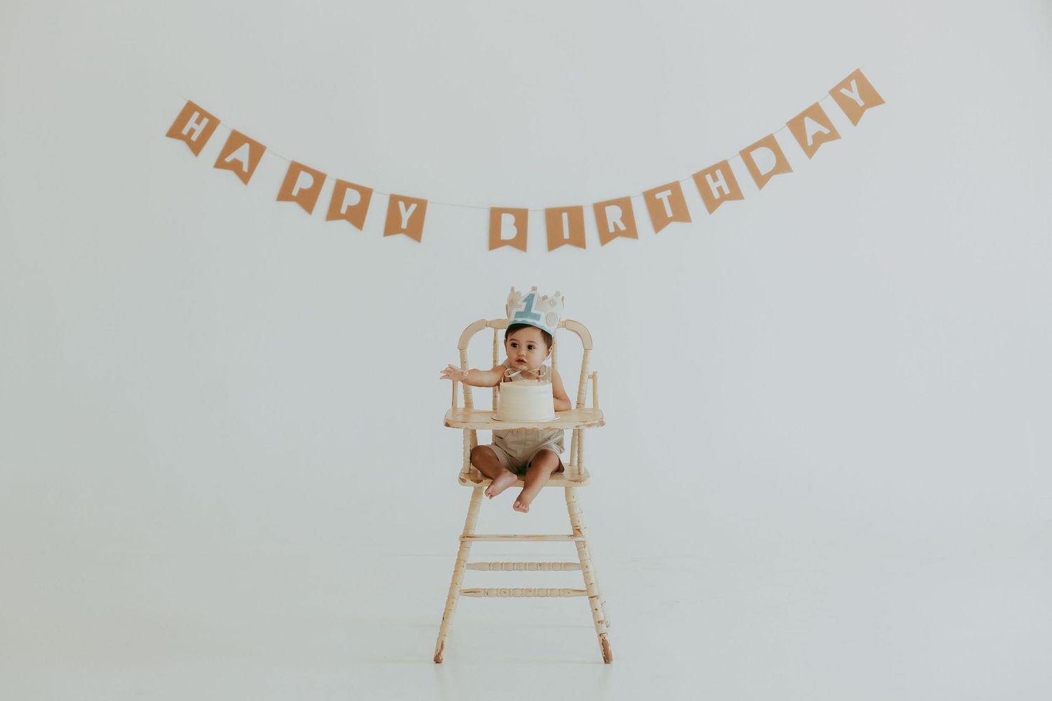 A rustic 'Happy Birthday' banner hangs with wooden clothespins against a neutral background.