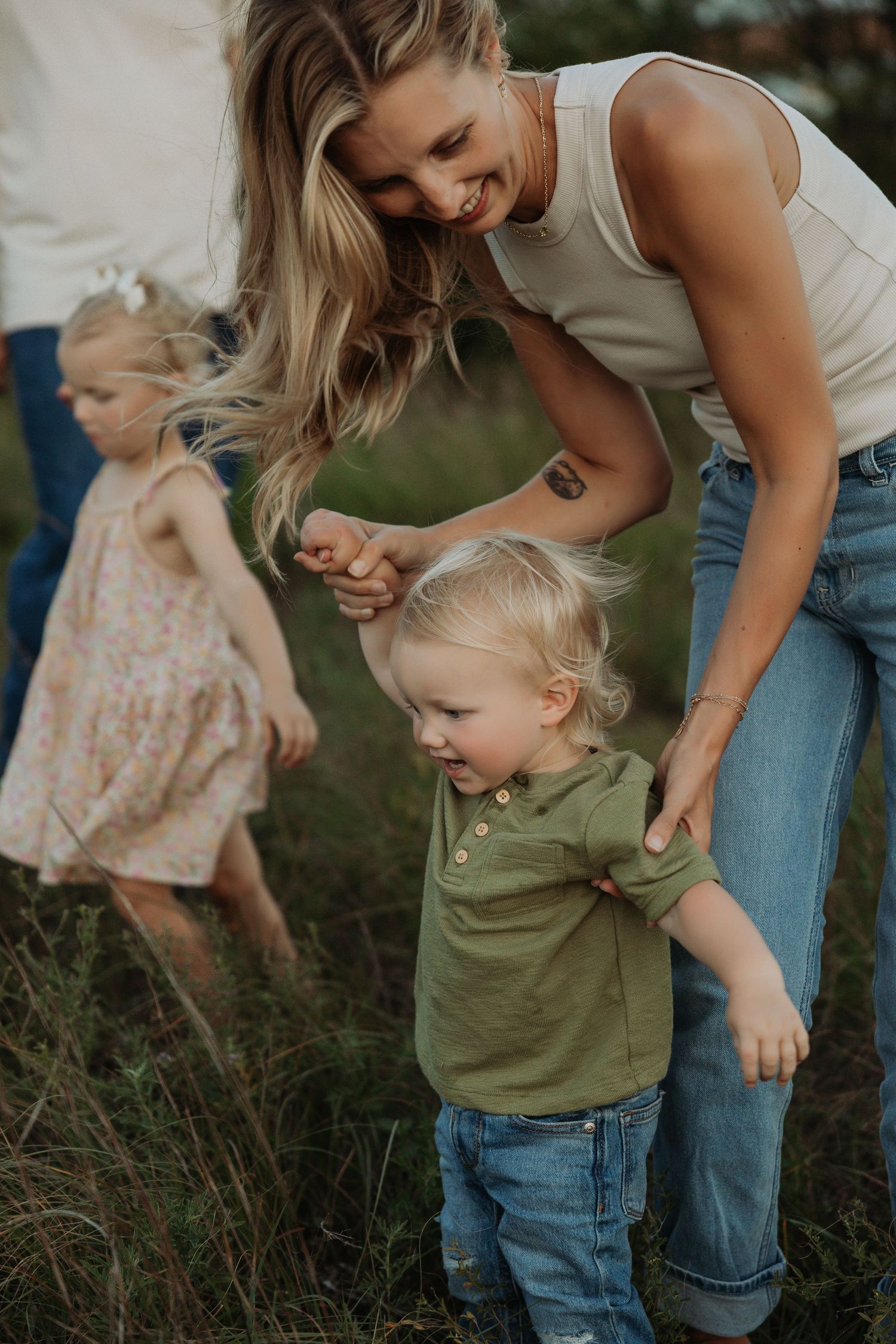 Candid moments of playful interaction in an outdoor family photoshoot.