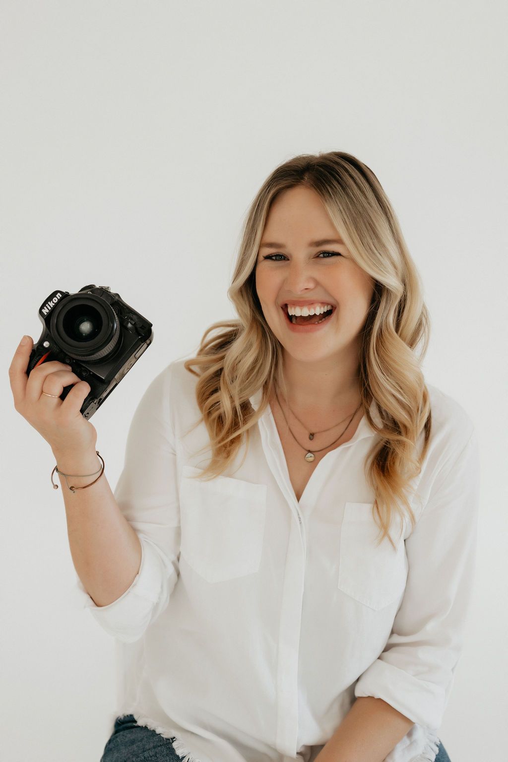 Candid studio shots of photographer showing camera and laughing.