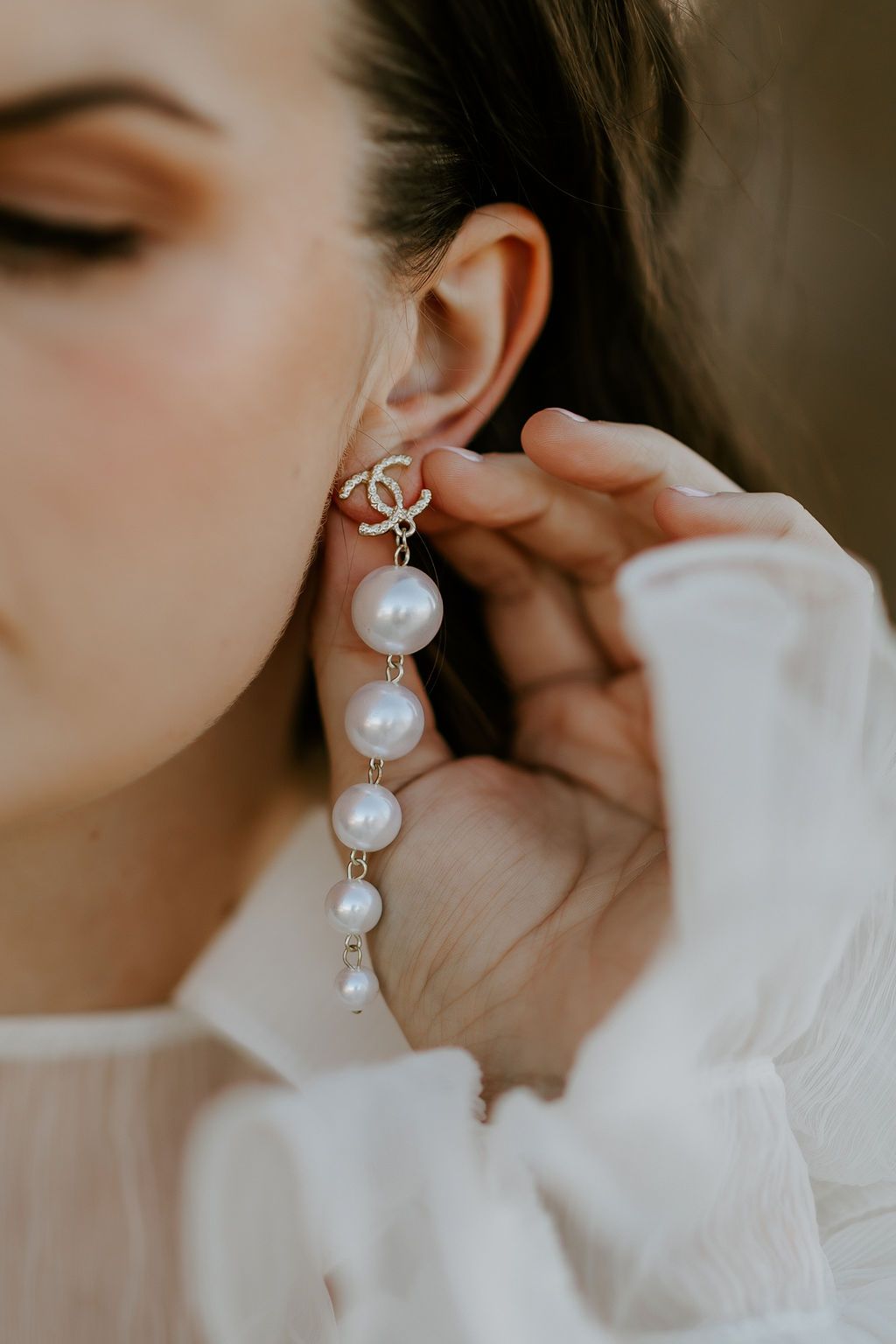 Delicate pearl drop earrings shown in romantic close-up detail shots.