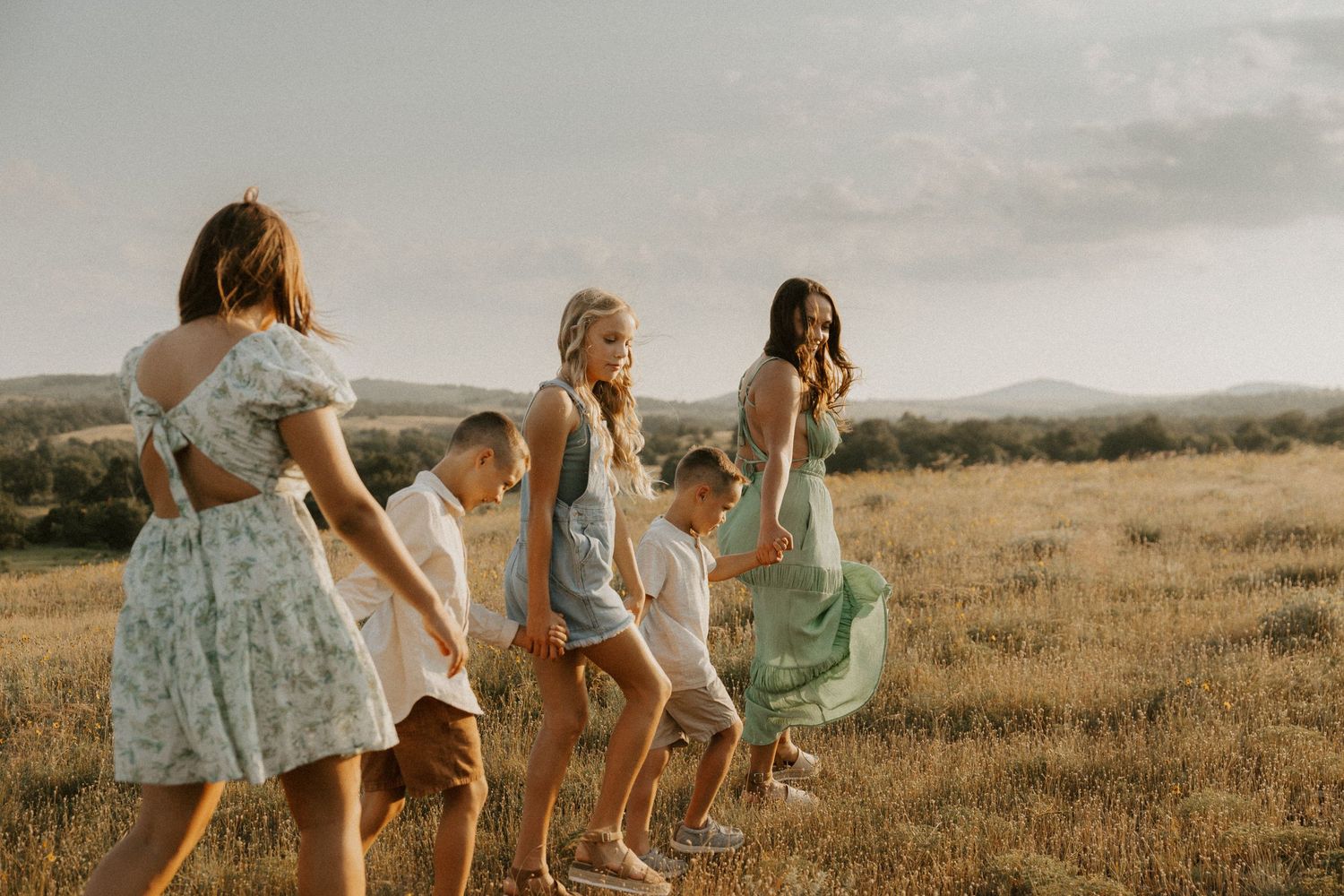 Group lounging in a sun-drenched meadow at sunset.