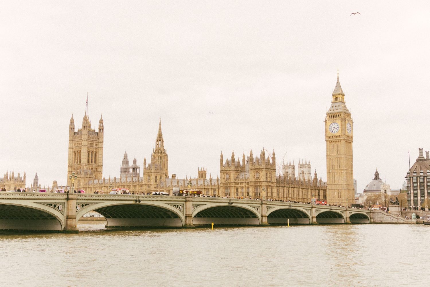 Historic Westminster Bridge spanning the River Thames with the iconic Big Ben and Houses of Parliament in London, England.