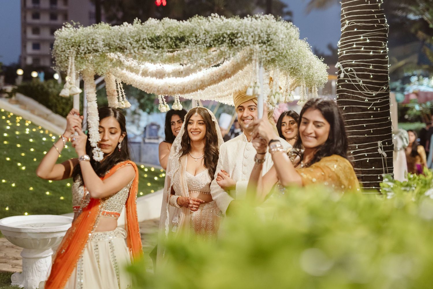Outdoor wedding festivities with string lights and joyful guests, captured by a wedding Photographer in Mumbai, Wedding photographer near me