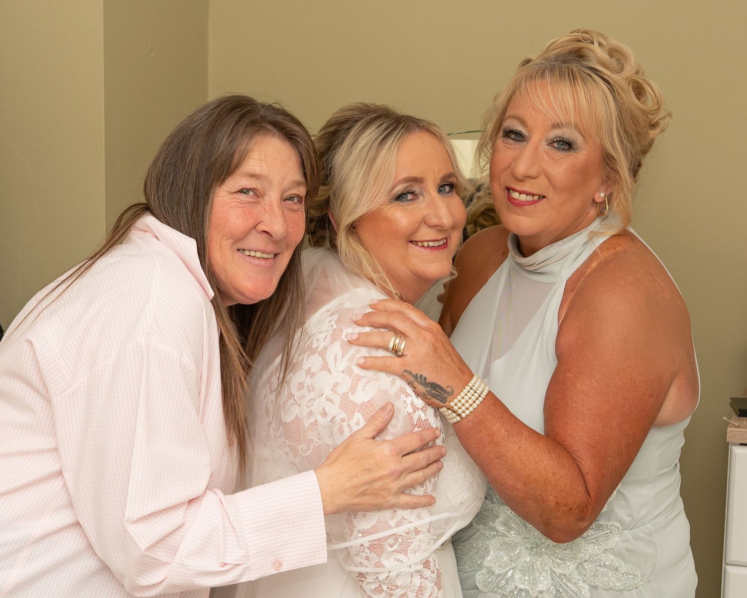 Group photos showing formal attire and embraces against a neutral background.