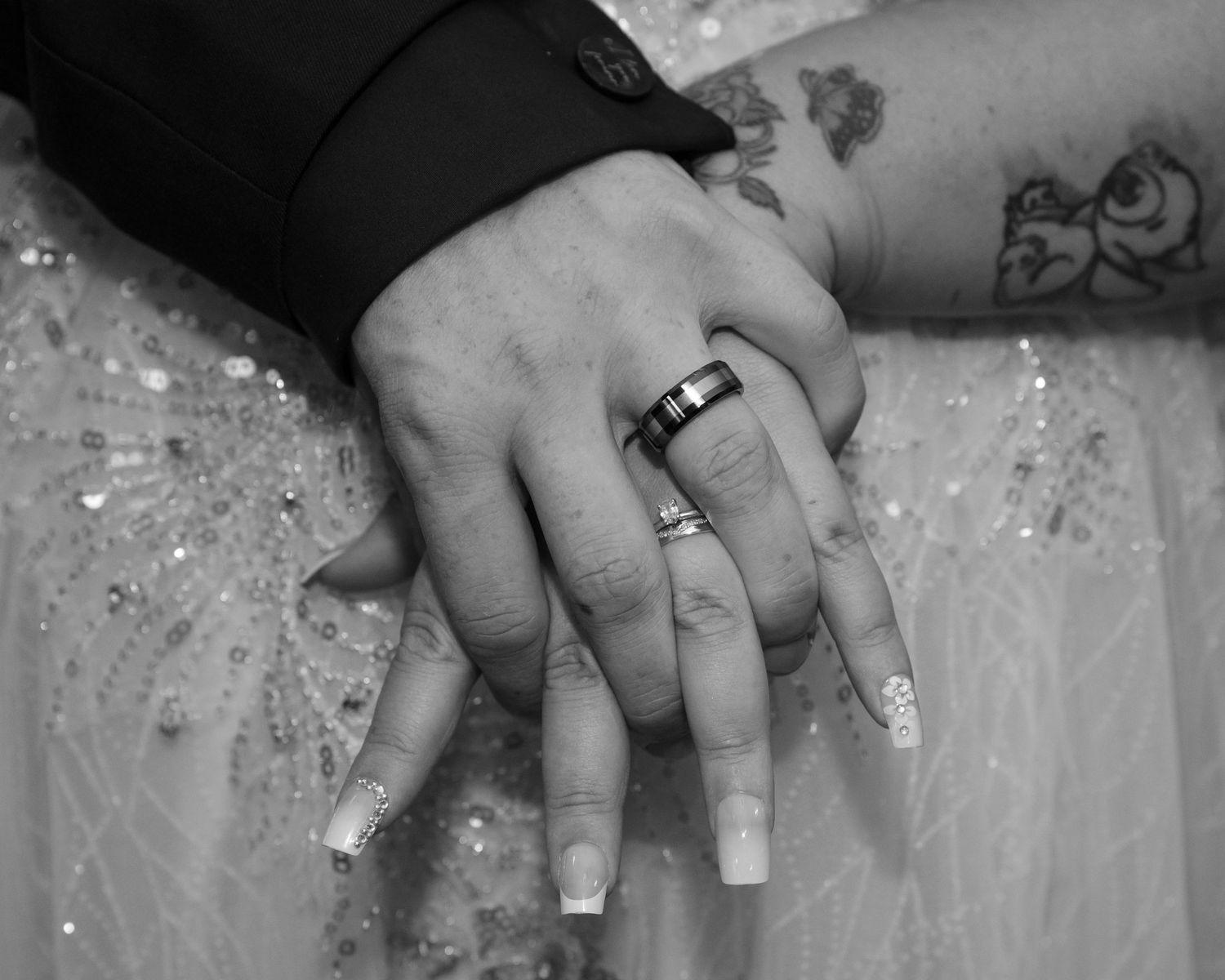 Close-up details of wedding dress beading and sparkles in black and white.