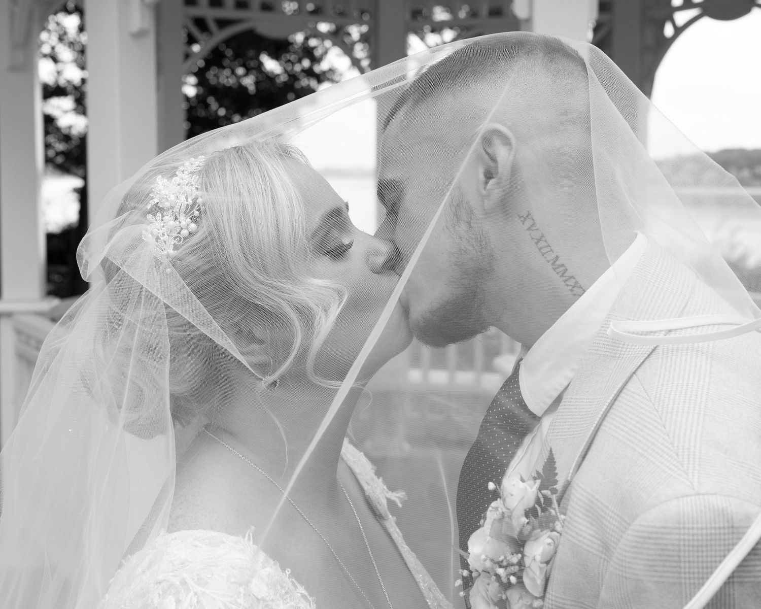 Black and white portraits of a couple sharing intimate wedding moments.