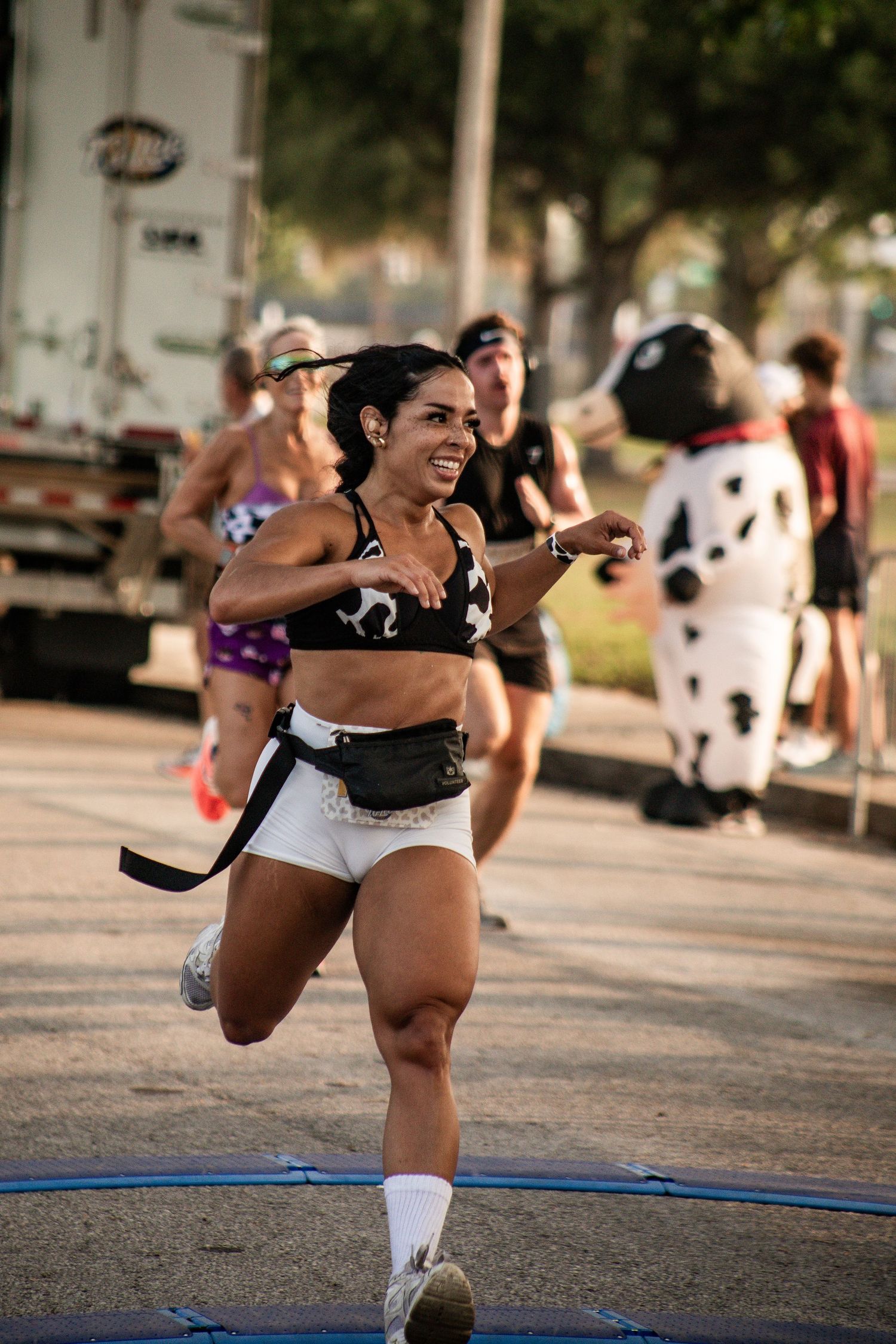 Female runner racing toward the finish during an outdoor 5K event. T.G. Lee Milk Run, Orlando, Florida. Goodreau.co