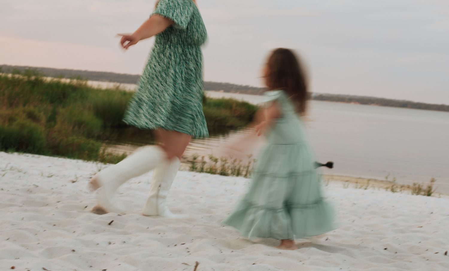 Artistic motion blur photograph of a mother and daughter running together on the beach in central Florida. Goodreau.co