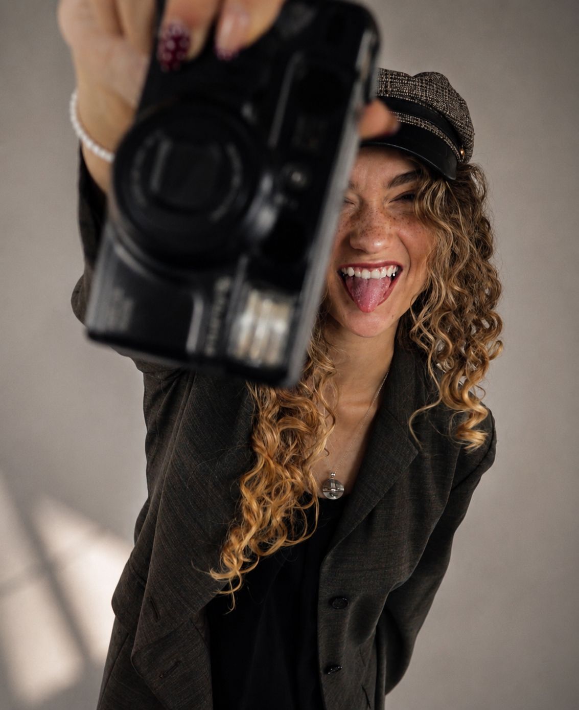 Brianna Goodreau holding a 35mm film camera, photographer and founder of Goodreau.co