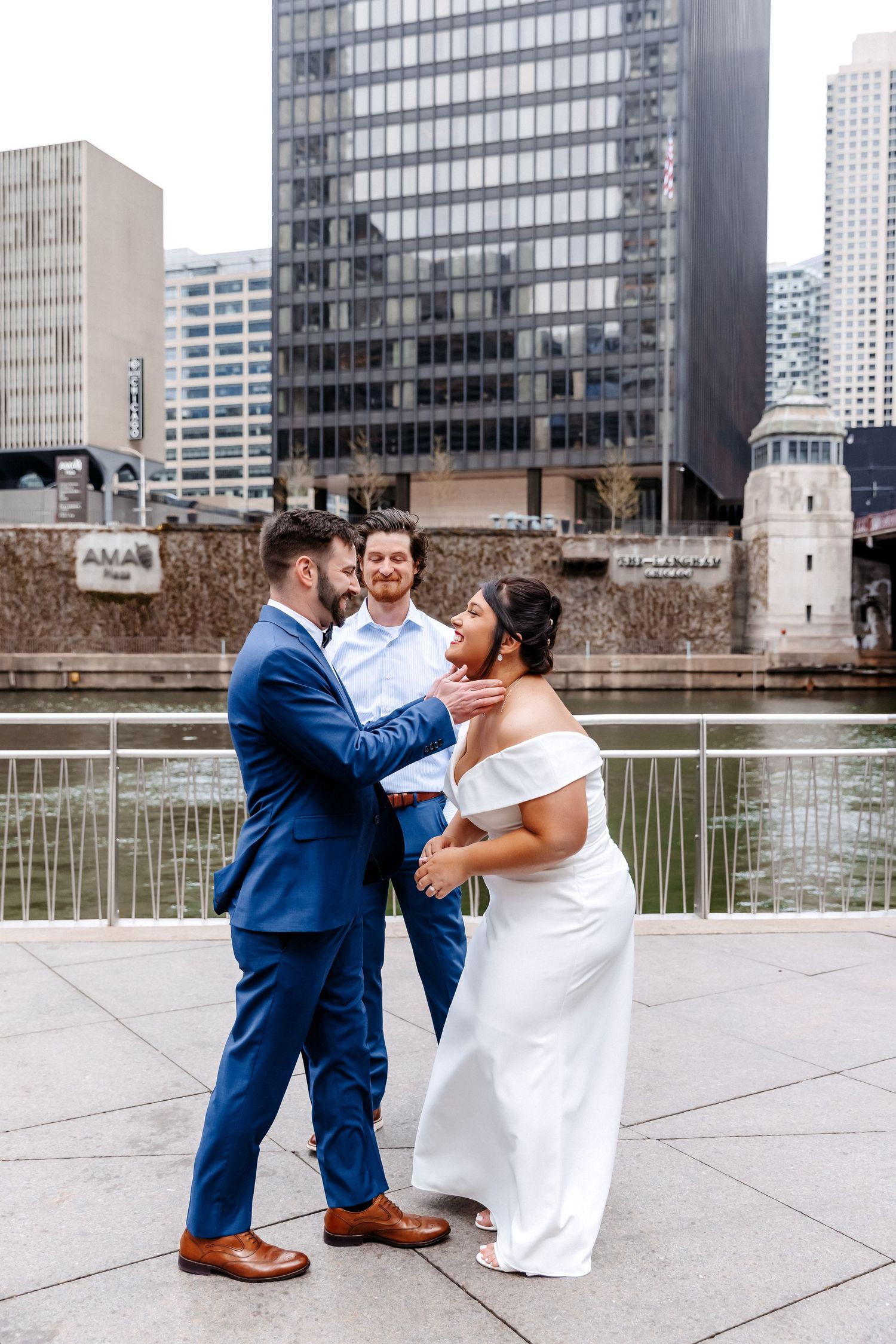 Bride and groom share joyful moment with officiant during urban Chicago Riverwalk wedding ceremony.