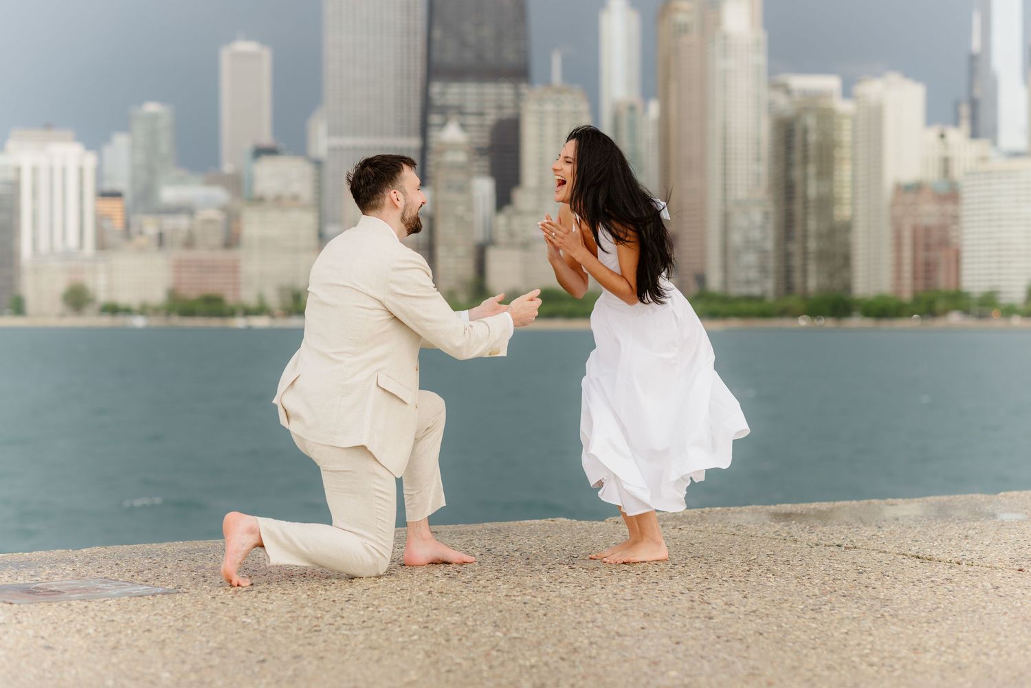 Romantic marriage proposal on Chicago waterfront with stunning city skyline backdrop at dusk.