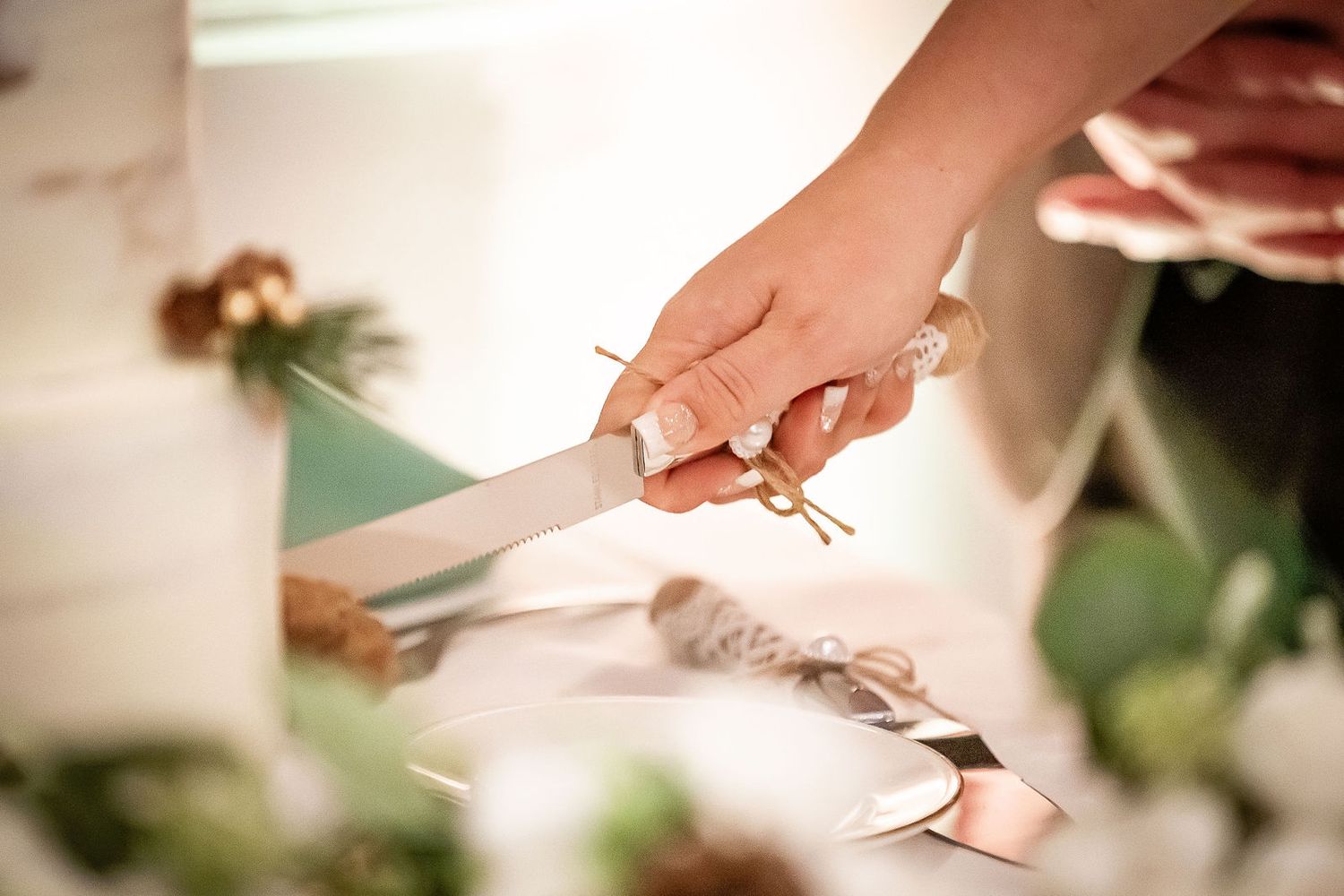 Bride and groom cutting their elegant wedding cake together at the reception.