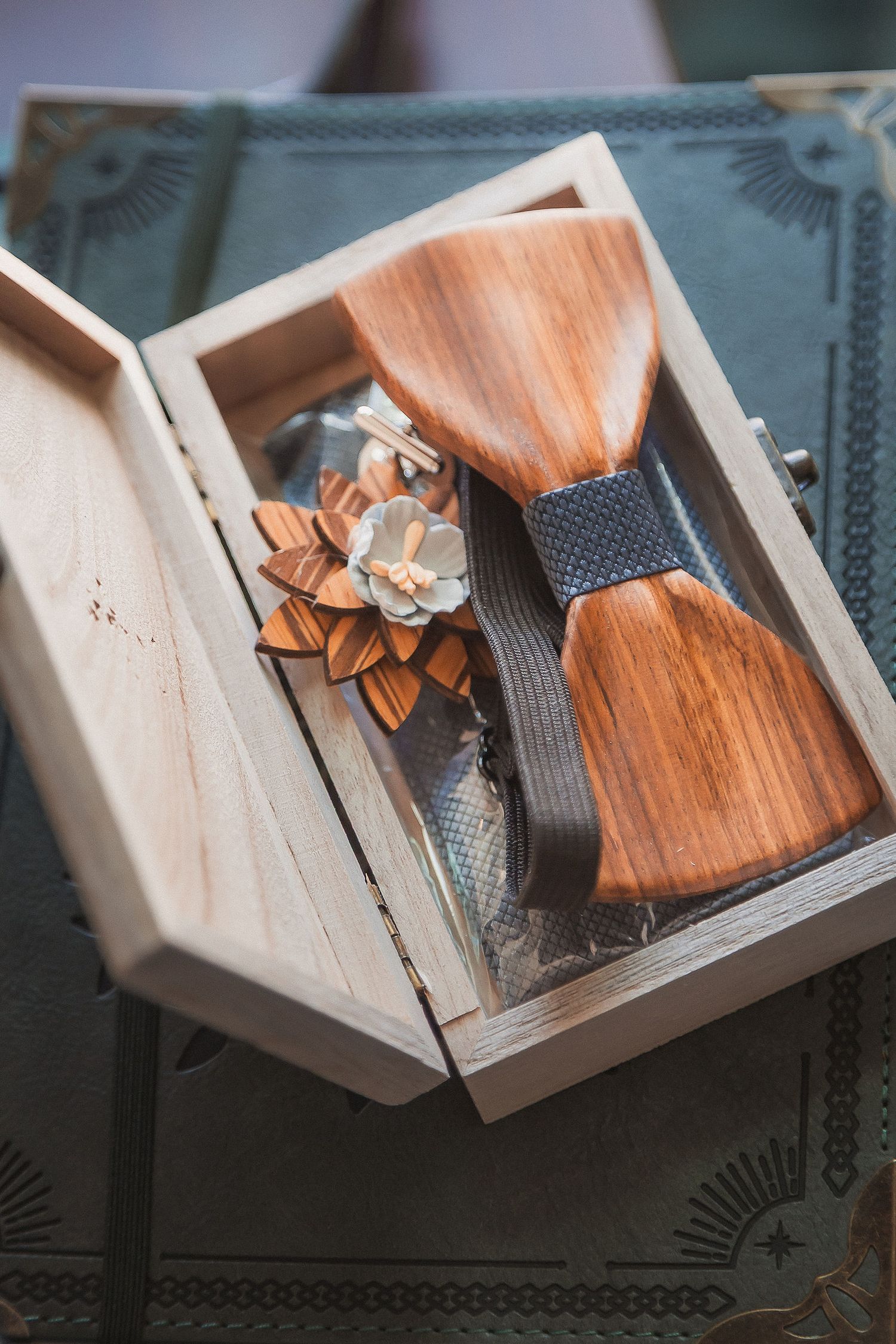 Elegant wooden bow tie and floral boutonniere displayed in a wooden keepsake gift box.