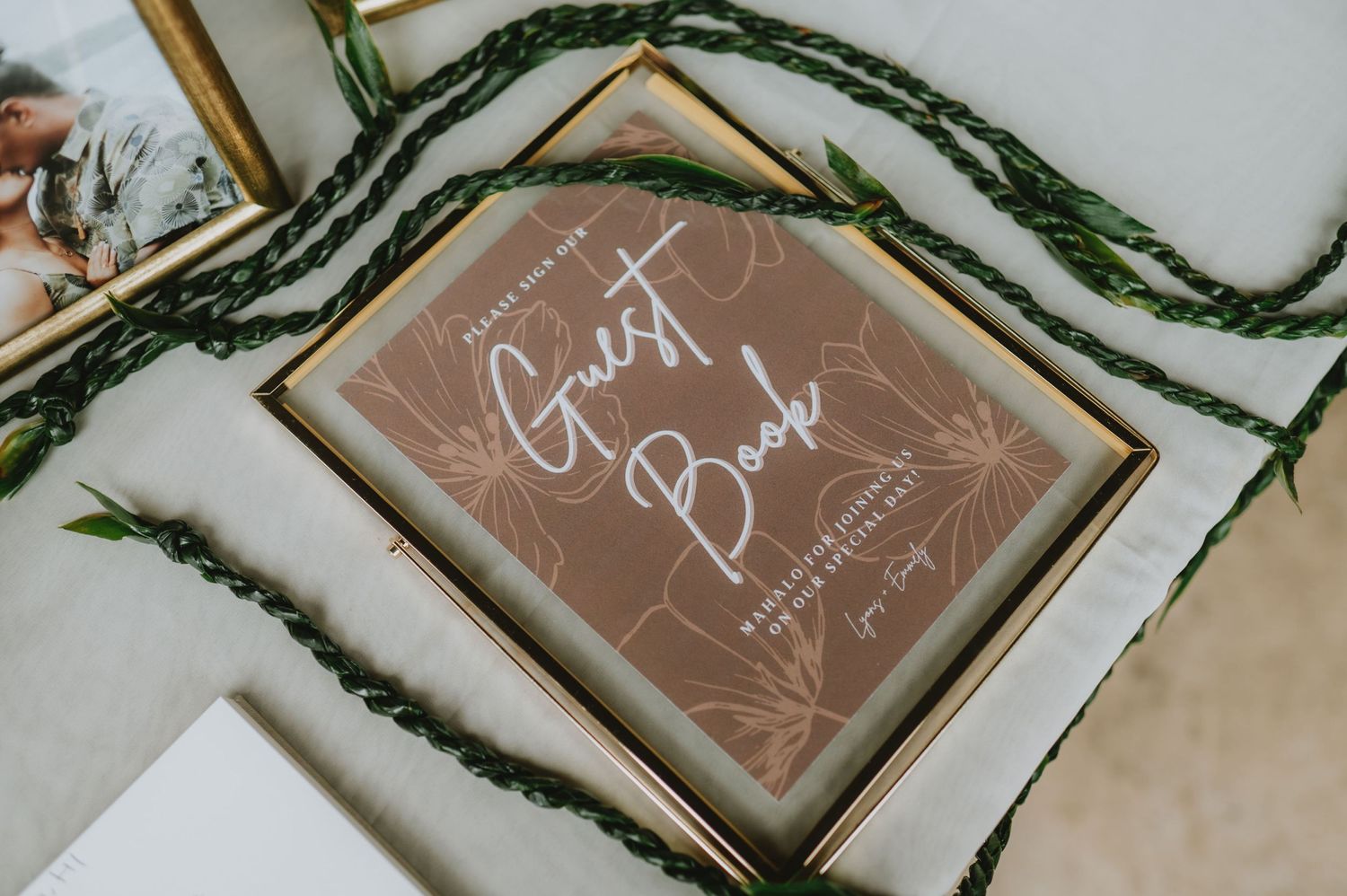 Wooden framed signs with handwritten text displayed at a wedding event.