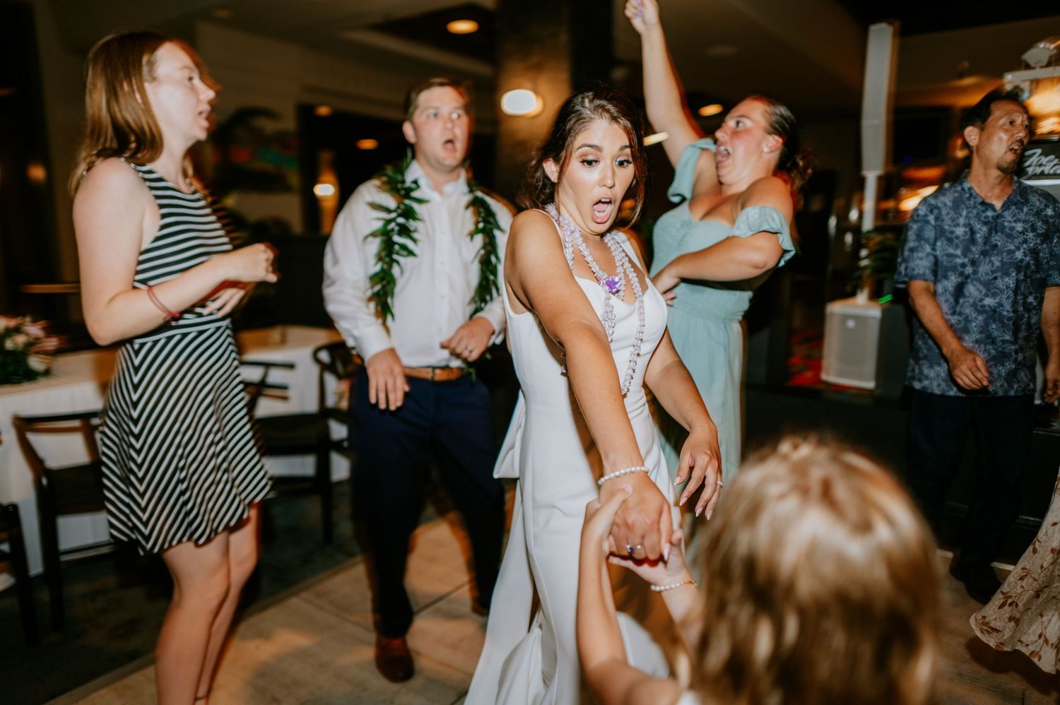 Wedding reception dance party with guests moving to the music.