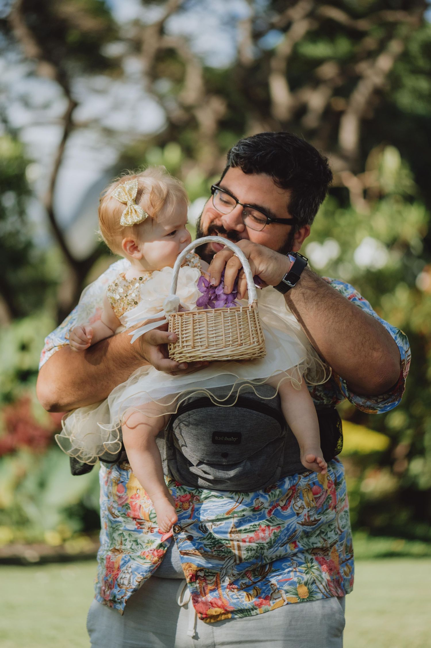 Sweet candid moments between parent and child during outdoor celebration.