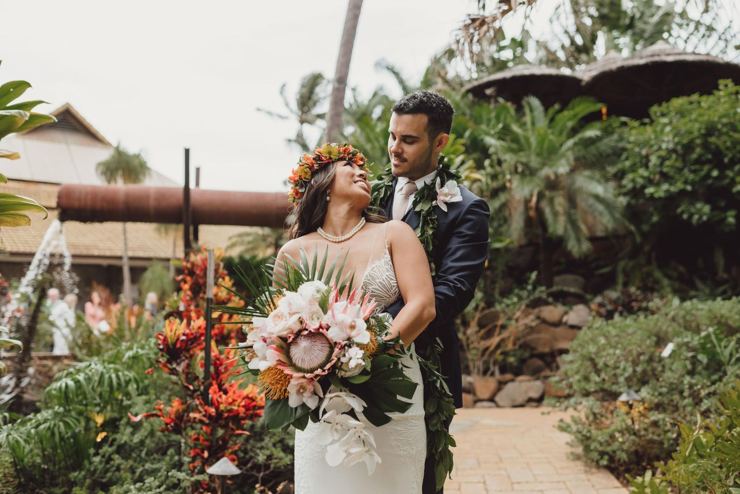 Wedding celebration with tropical floral arrangements in a garden setting.