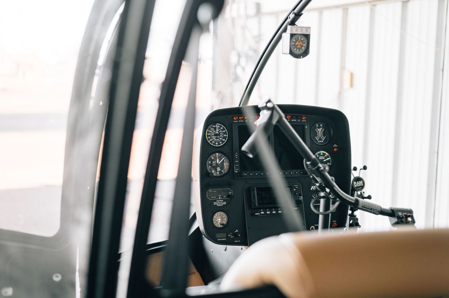 Interior view of helicopter cockpit instruments and controls.