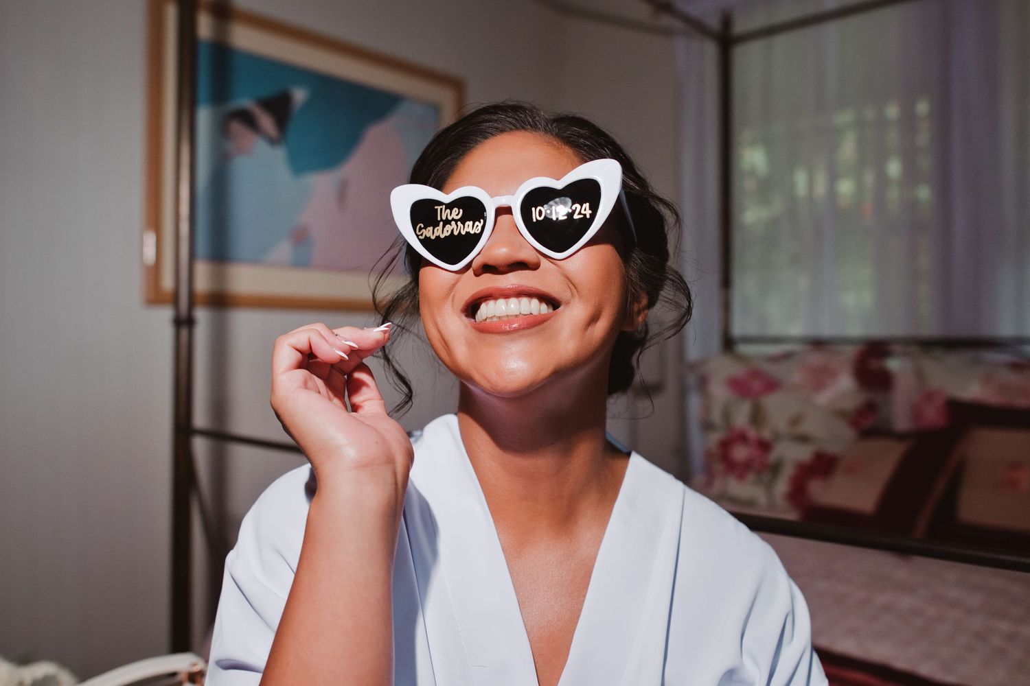 Smiling bride in white robe wearing heart-shaped 