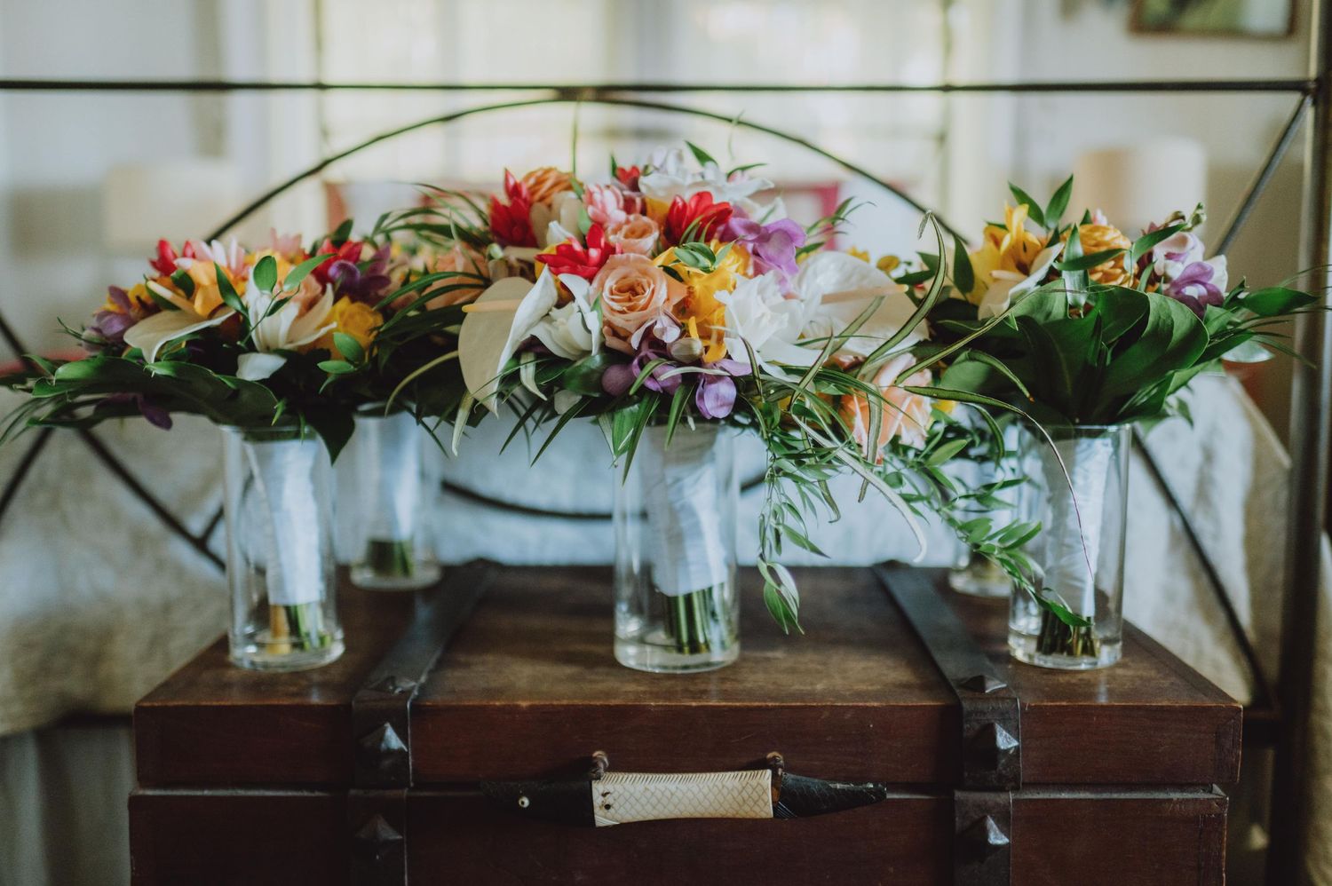 Elegant floral arrangements with pink and white blooms displayed at a wedding venue.