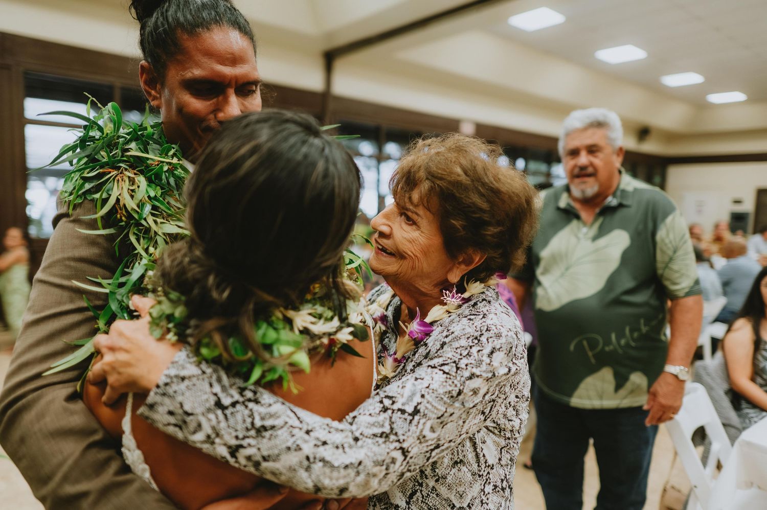 Wedding guests celebrating at a reception with tropical-themed decorations.