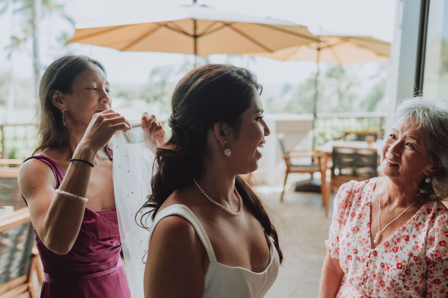 Wedding reception gathering with guests mingling under covered outdoor venue.