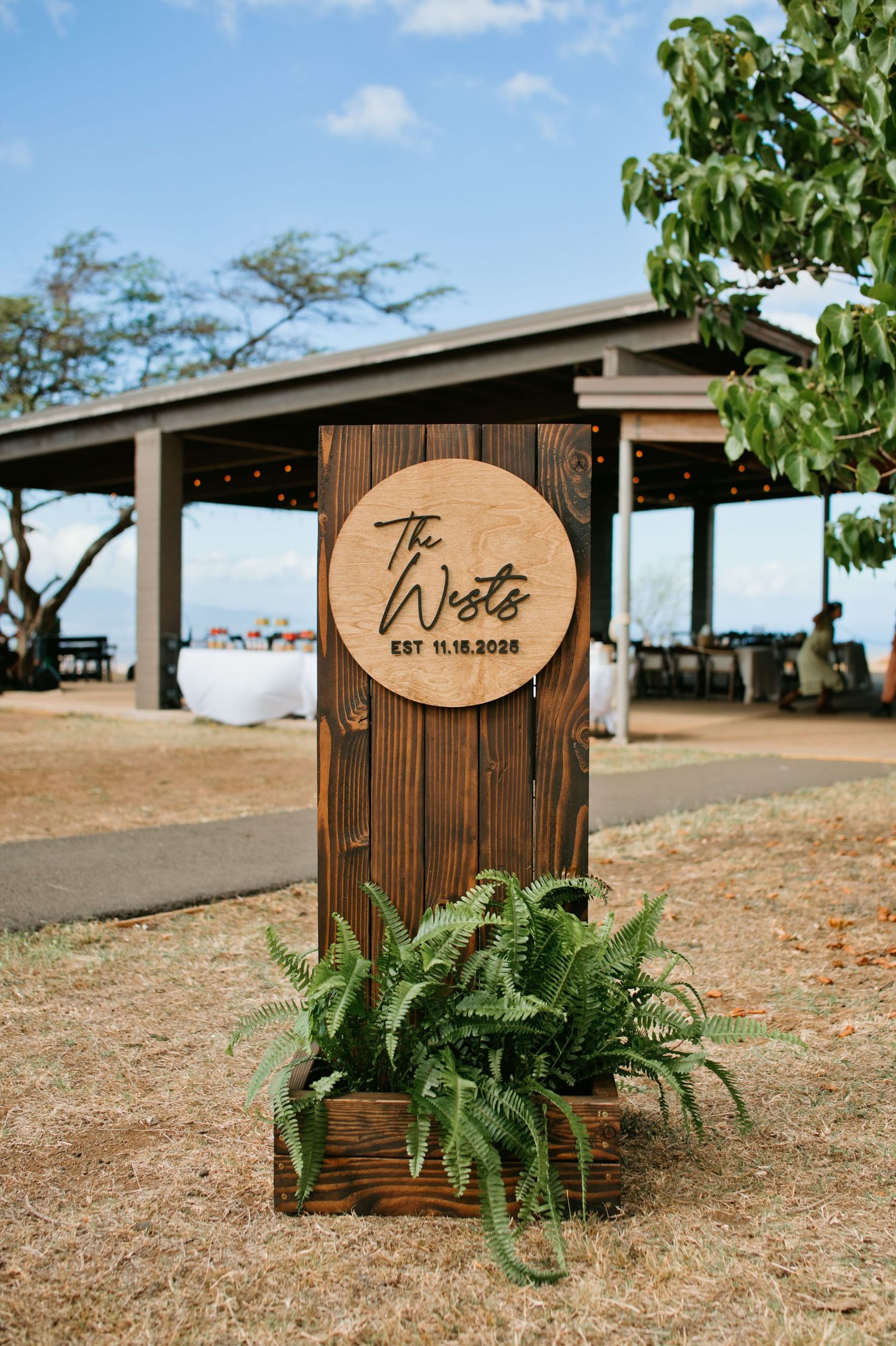 Wooden welcome sign for Morgan and Kaʻena’s wedding.