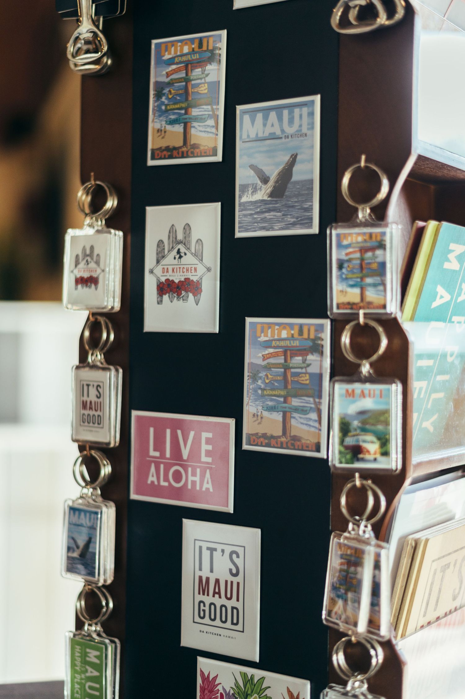 Wall display of Hawaiian-themed artwork and decorative signs including Aloha messages.