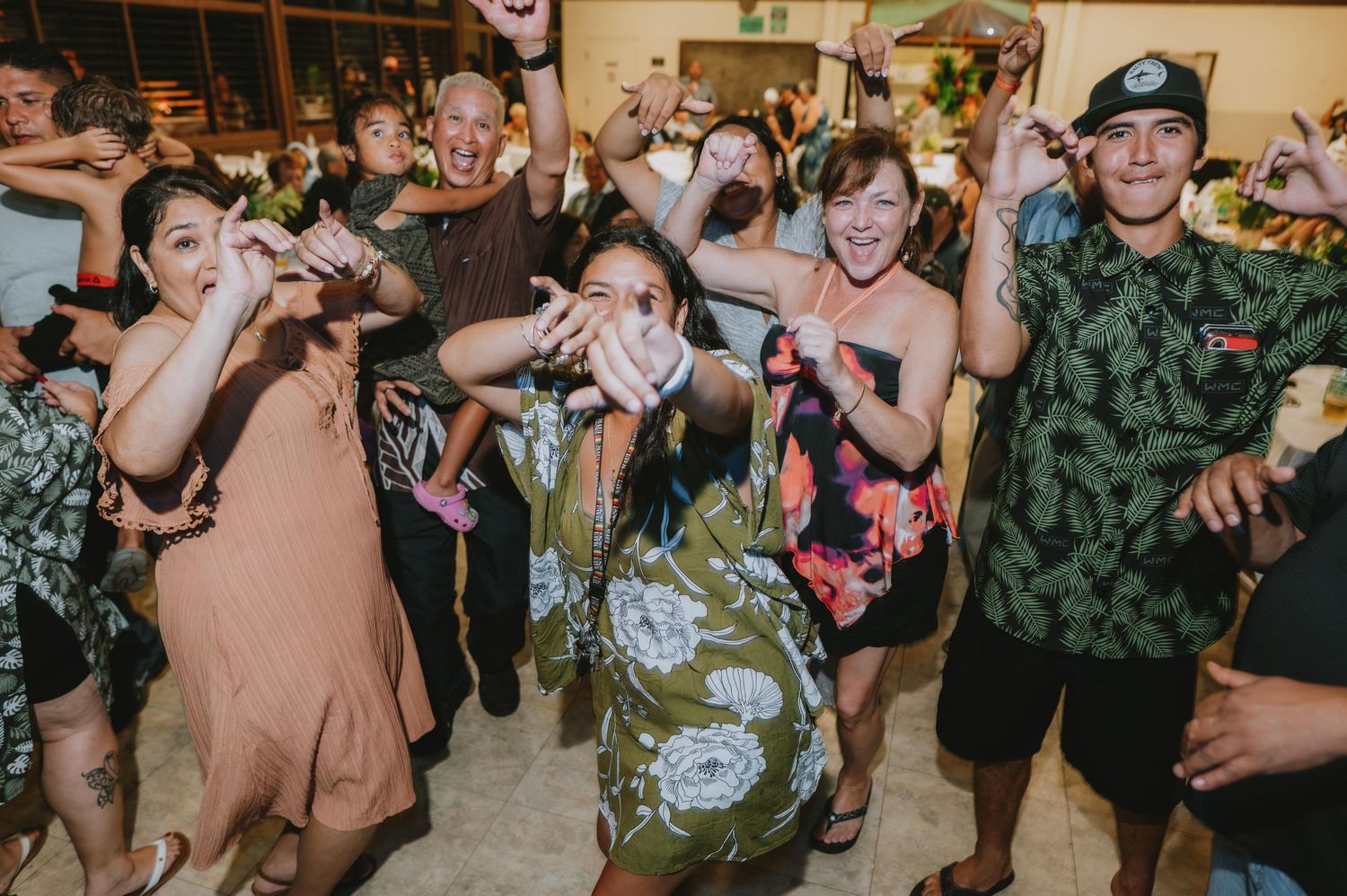 Energetic wedding party dancing and having fun during reception festivities.