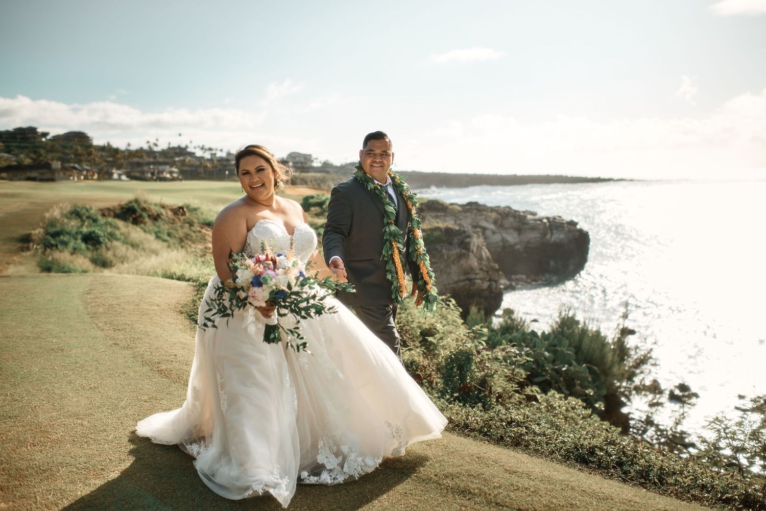 Bride and groom walking along the cliffs at Maui Pineapple Chapel in Kapalua, Hawai'i