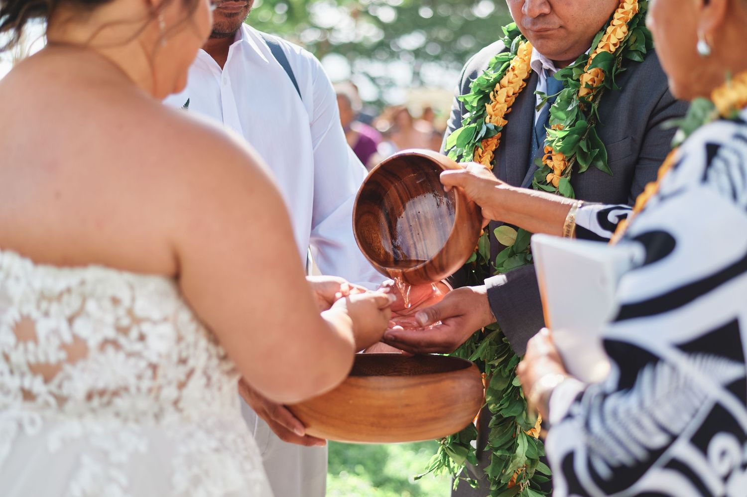 Close-up of hands during wedding ceremony exchange.